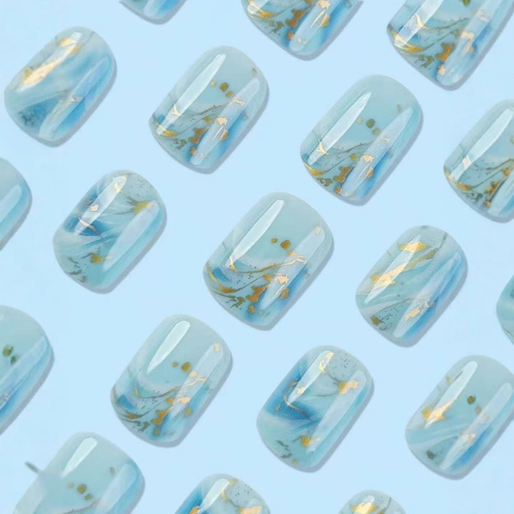 Acrylic nail set with luxurious marble design and gold accents Stornfield