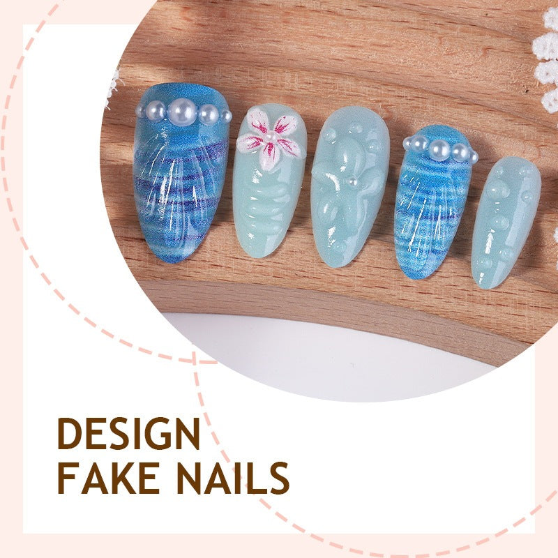 Nail art set with unique aquatic motifs and decorative accents Stornfield