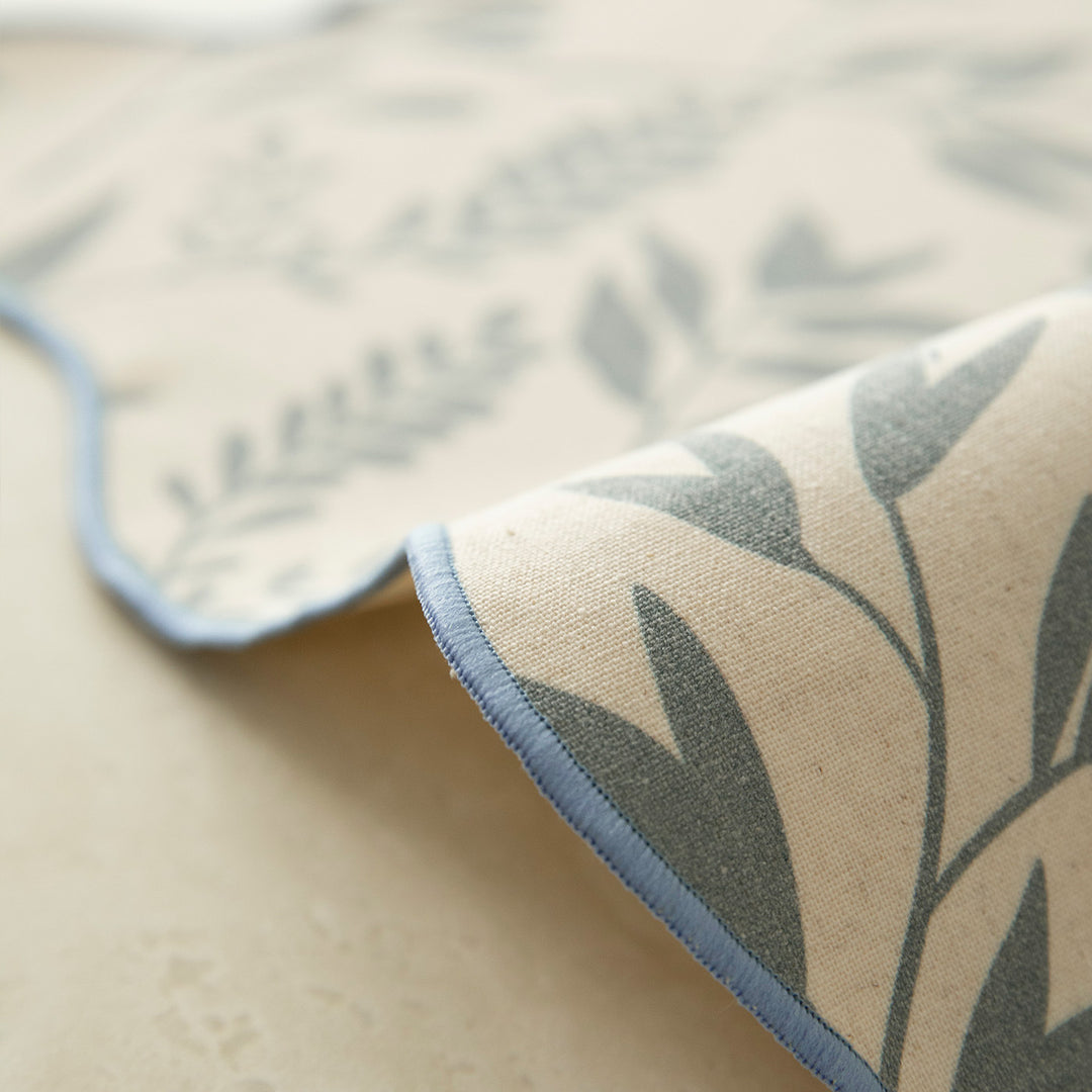 Shaped placemat made of cotton-linen with wavy edge and leaf pattern
