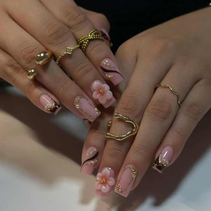 Artificial nail art with flower and glitter effects Stornfield