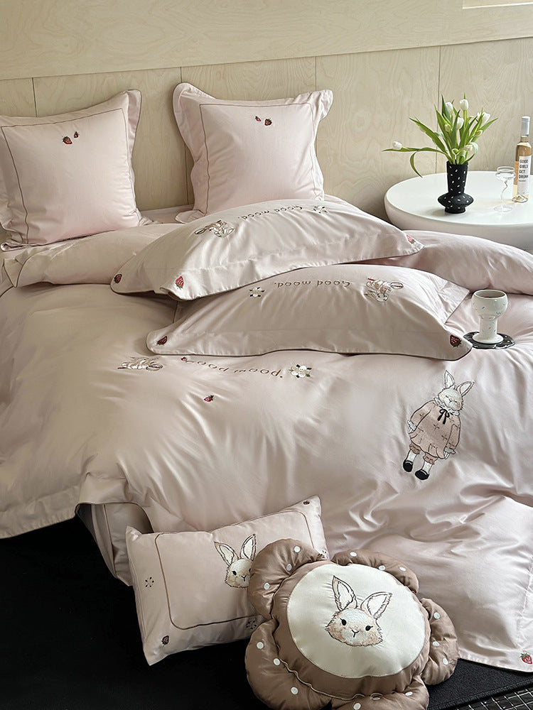 Fine cotton satin bedding set with elaborate bunny embroidery and piped edge