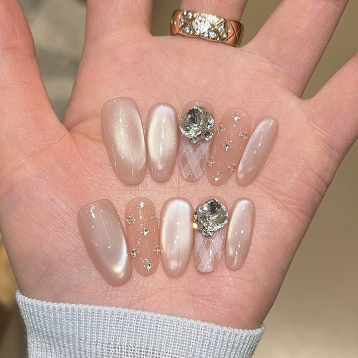 Elegant artificial nails with shimmering effects and rhinestone accents Stornfield