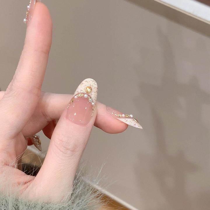 Artificial nails with elegant accents and rhinestone embellishments Stornfield