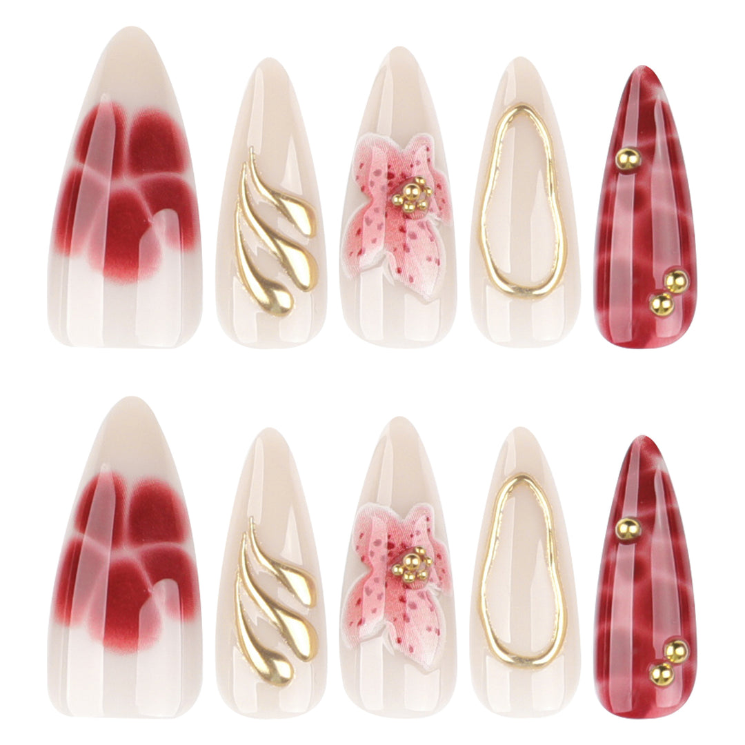 Artful stiletto nails with elegant floral designs and glitter accents Stornfield