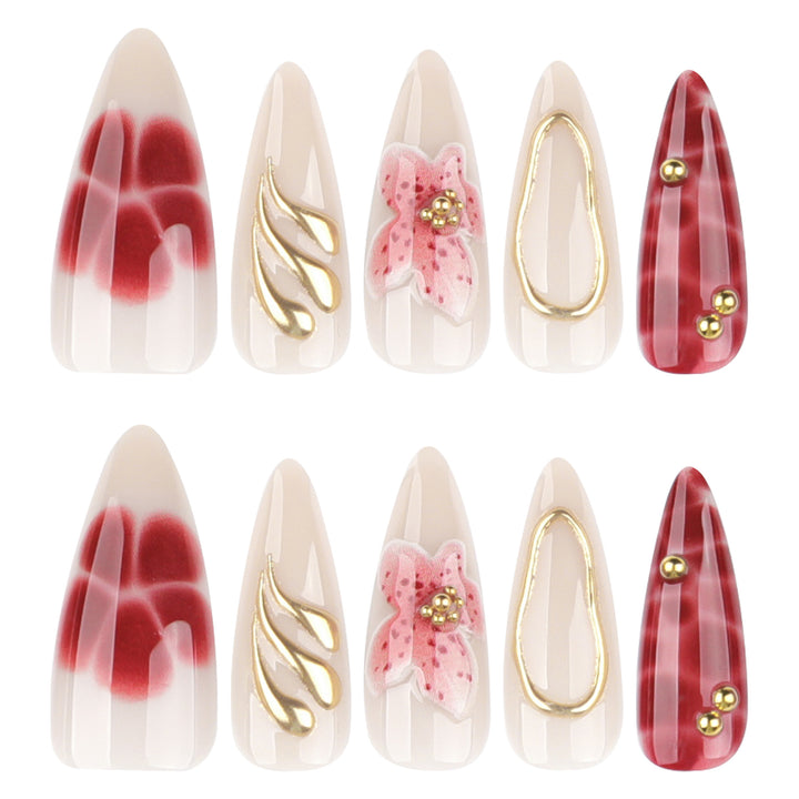 Artful stiletto nails with elegant floral designs and glitter accents Stornfield