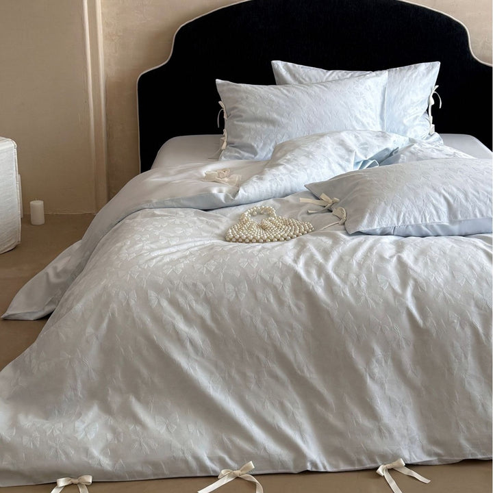 Luxurious cotton satin bed set with delicate ribbon ties and jacquard relief