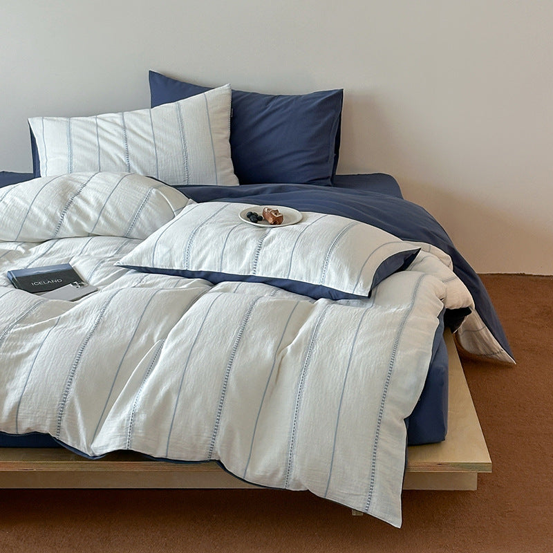 Reversible bedding set with textured striped look and fine quilting