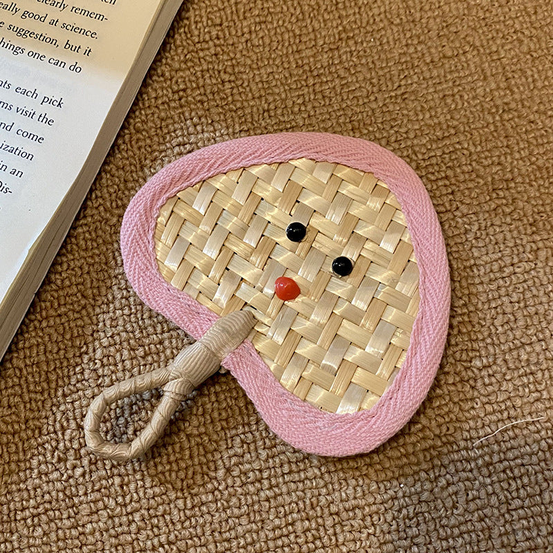Handcrafted fan with playful face motif Stornfield