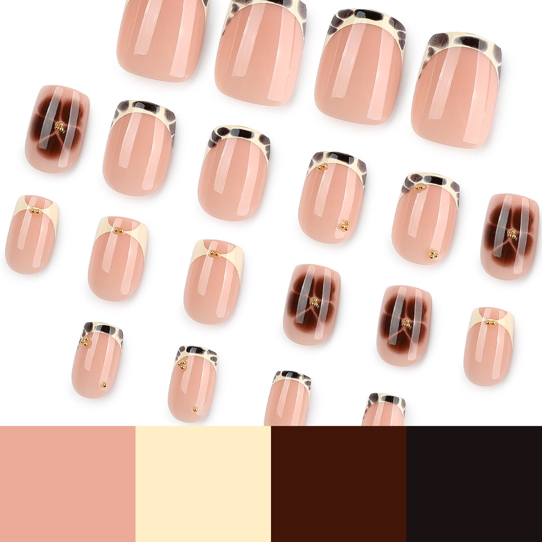 Artful nail extensions with an elegant giraffe pattern and golden accents Stornfield