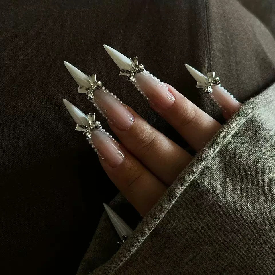Elegant artificial nail set with 3D rhinestone details and pointed accents Stornfield