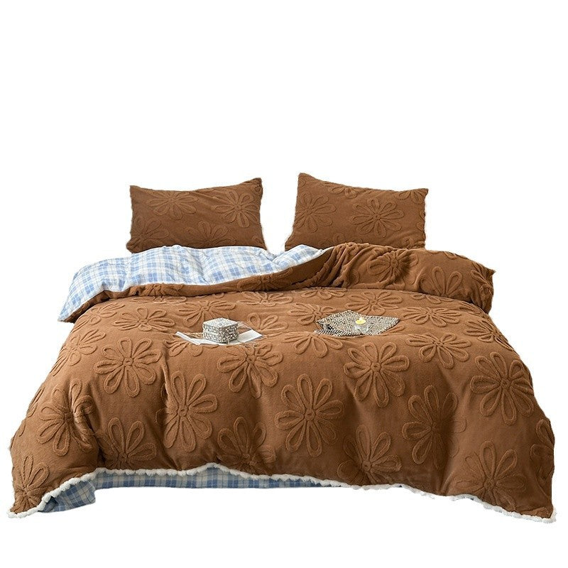 Plush bedding set with embossed floral relief and teddy trim
