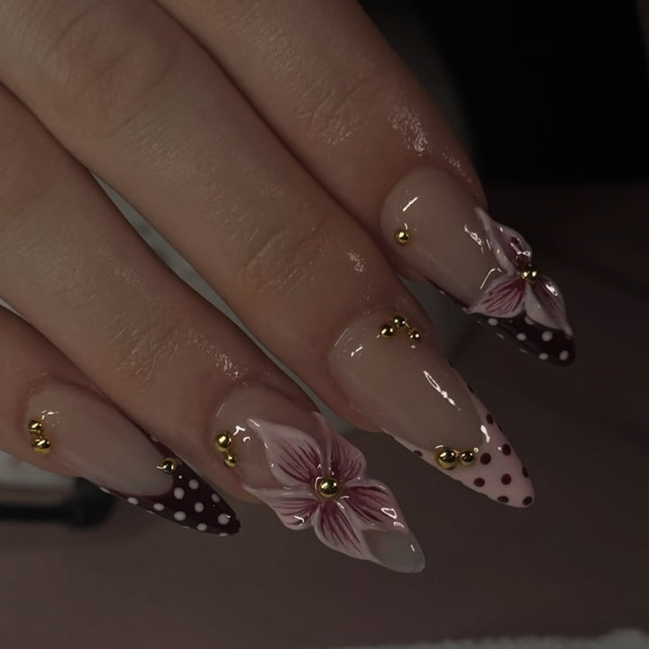 Artful stiletto nails with floral accents and glitter Stornfield