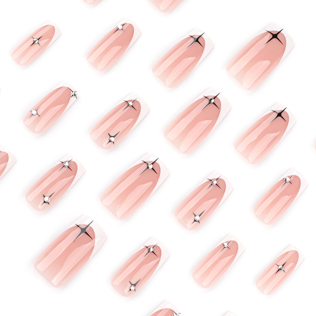 Artificial nail extensions with elegant French tip and glitter accents Stornfield