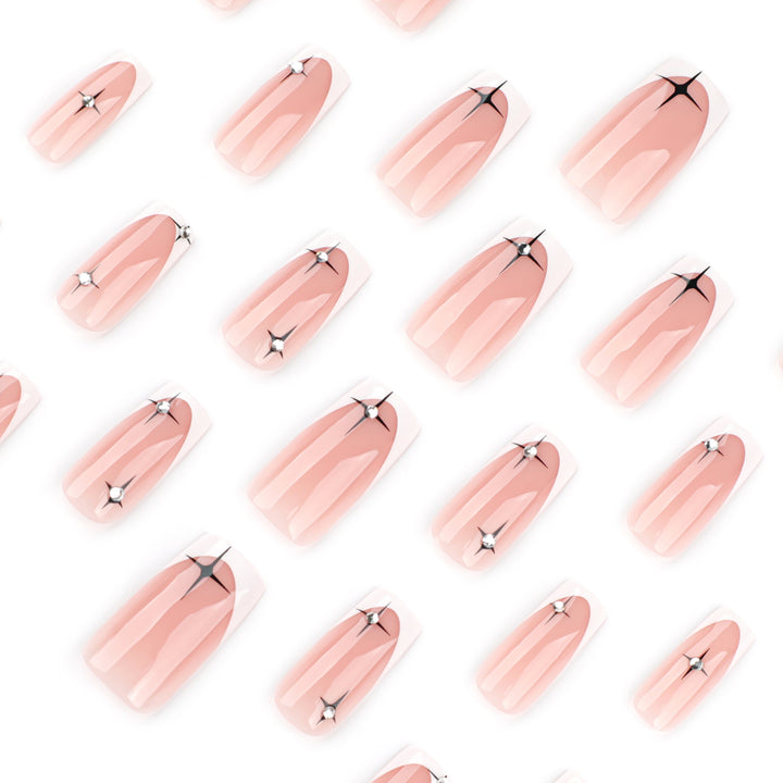 Artificial nail extensions with elegant French tip and glitter accents Stornfield