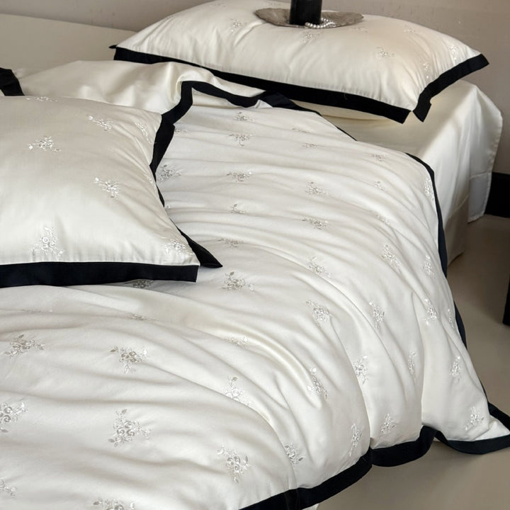 Noble cotton satin bedding set with tone-on-tone floral embroidery and contrasting piping