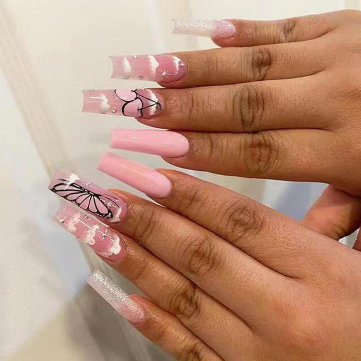 Artificial nail set with romantic butterfly designs and glitter accents Stornfield