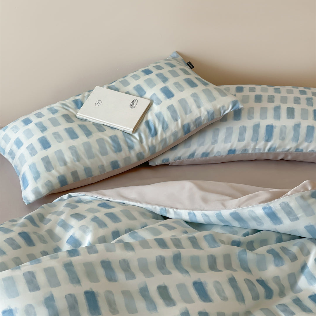 Luxurious satin bedding set with floral watercolor print, ruffled edges and reversible function