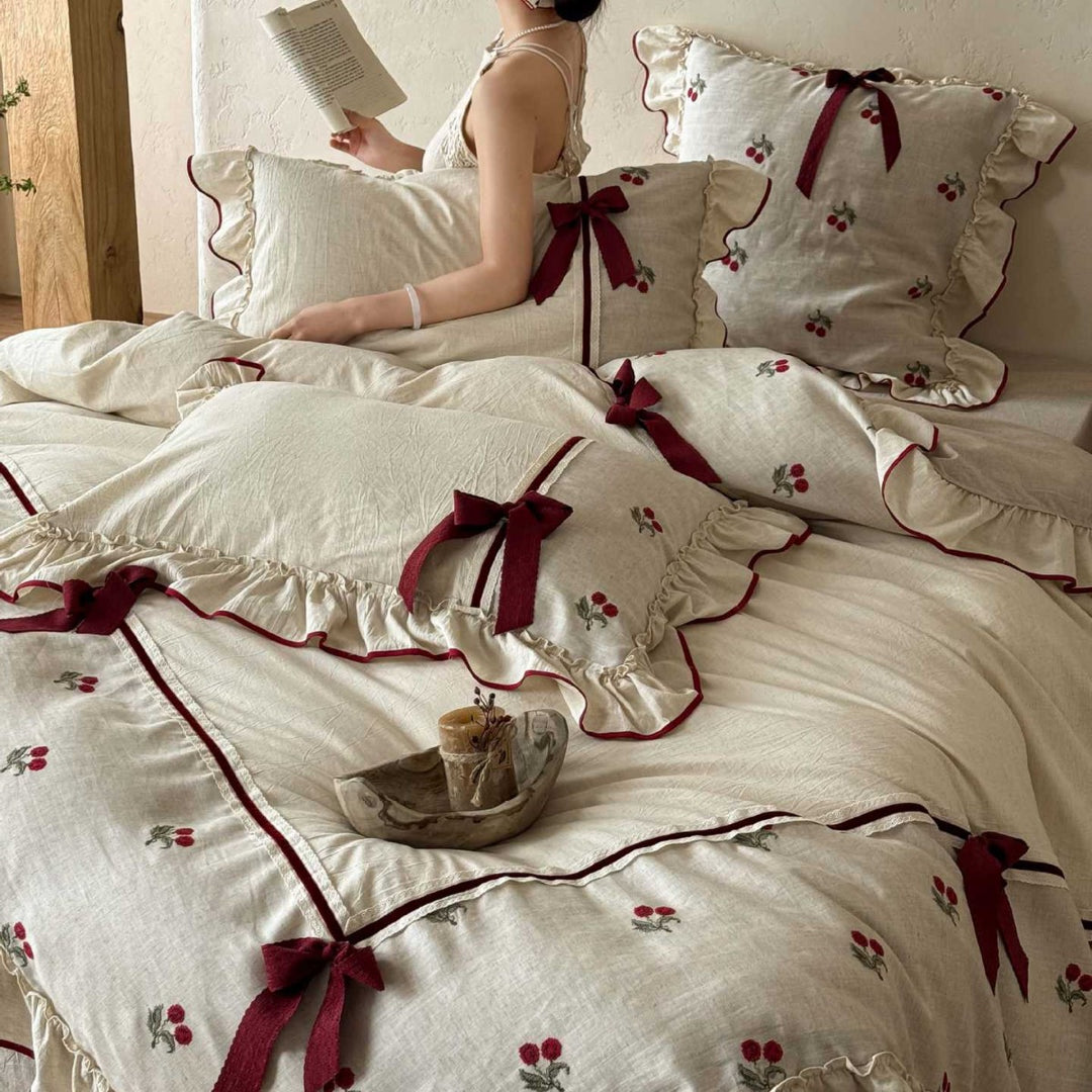 Country house bedding set made of linen-cotton blend with hand-embroidered cherry motifs, ruffles and decorative bows