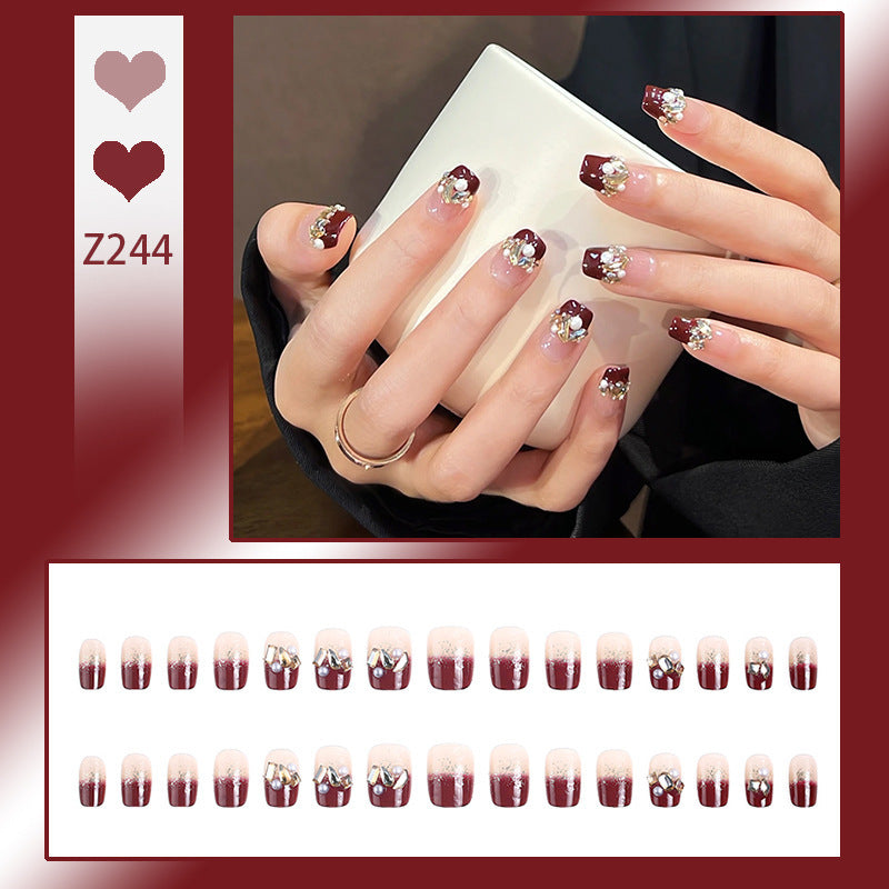 Glamorous artificial nails with decorative pearl and glitter embellishments Stornfield