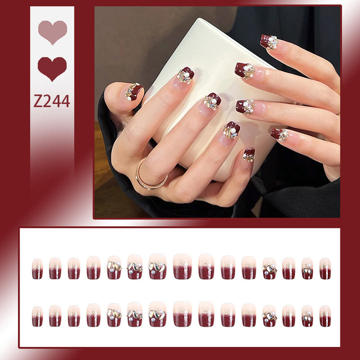 Glamorous artificial nails with decorative pearl and glitter embellishments Stornfield
