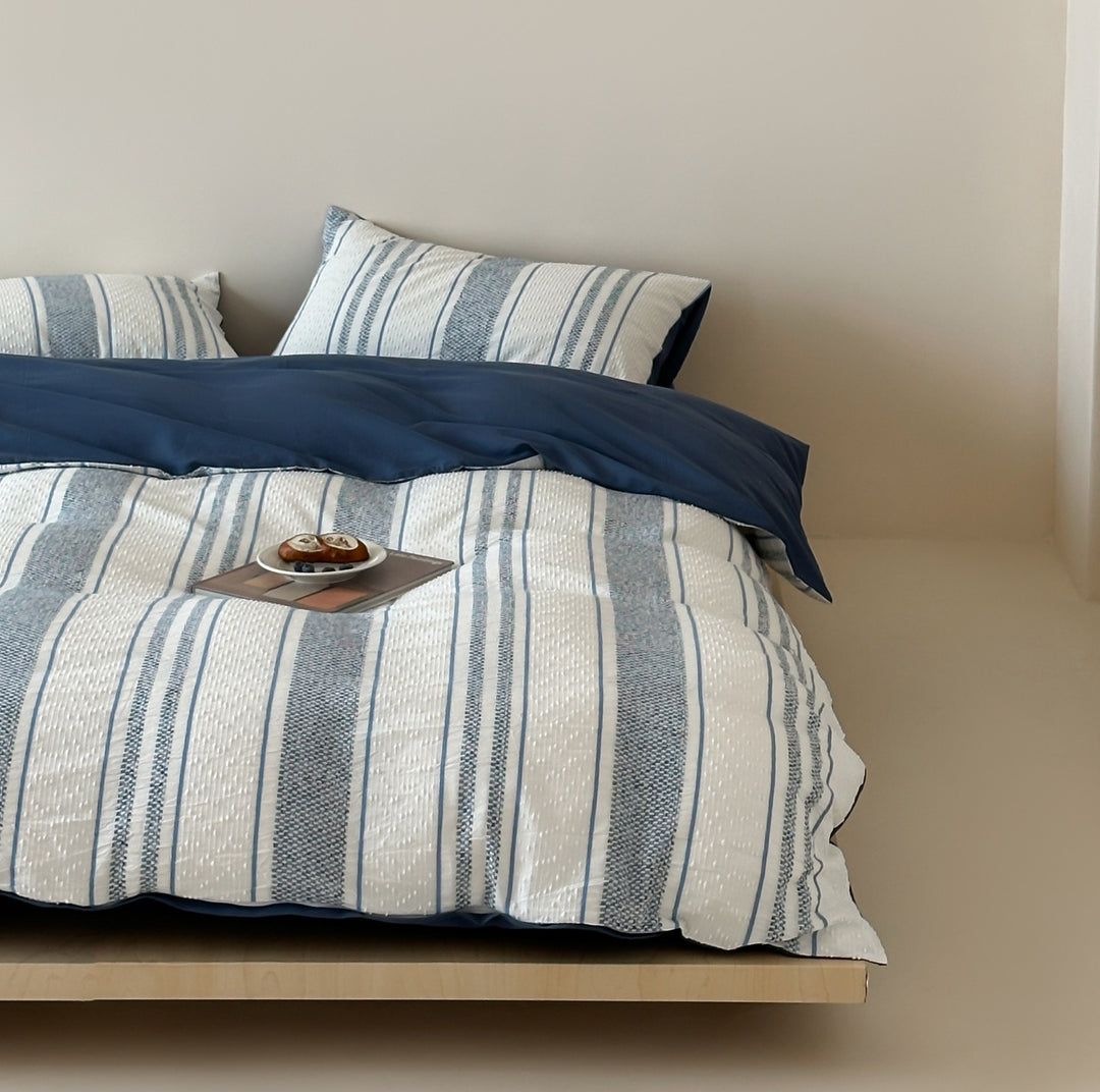 Reversible bedding set with textured striped look and fine quilting