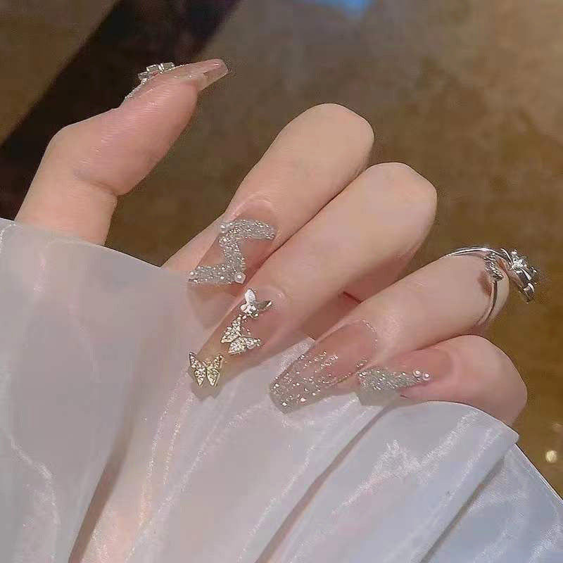 Artificial nails with sparkling rhinestone and bow accents Stornfield