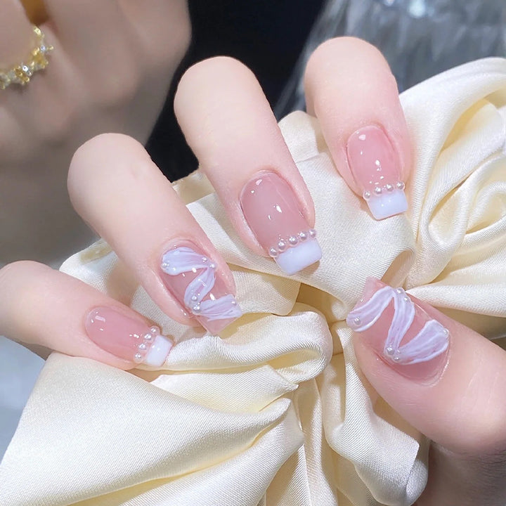 Elegant artificial nail set with stylish wave pattern and pearl accents Stornfield