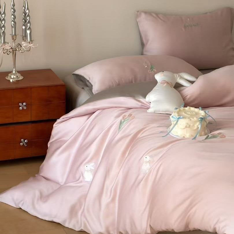 Luxurious satin bedding set with embroidered cherry motifs, reversible function and plush bunny pillow