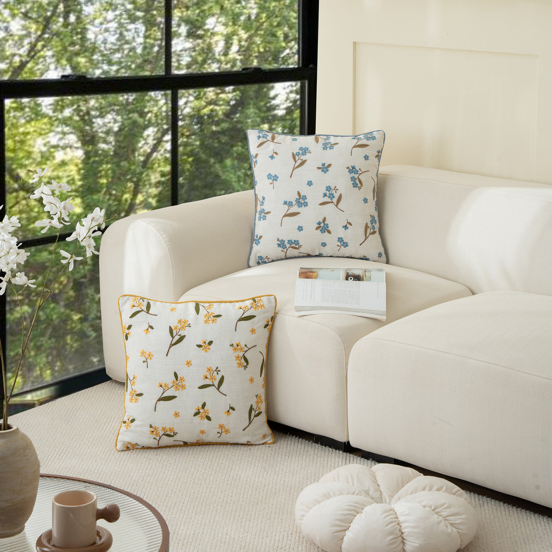 Decorative embroidered cushion cover made of linen blend with floral yellow flower appliqué and piping Stornfield