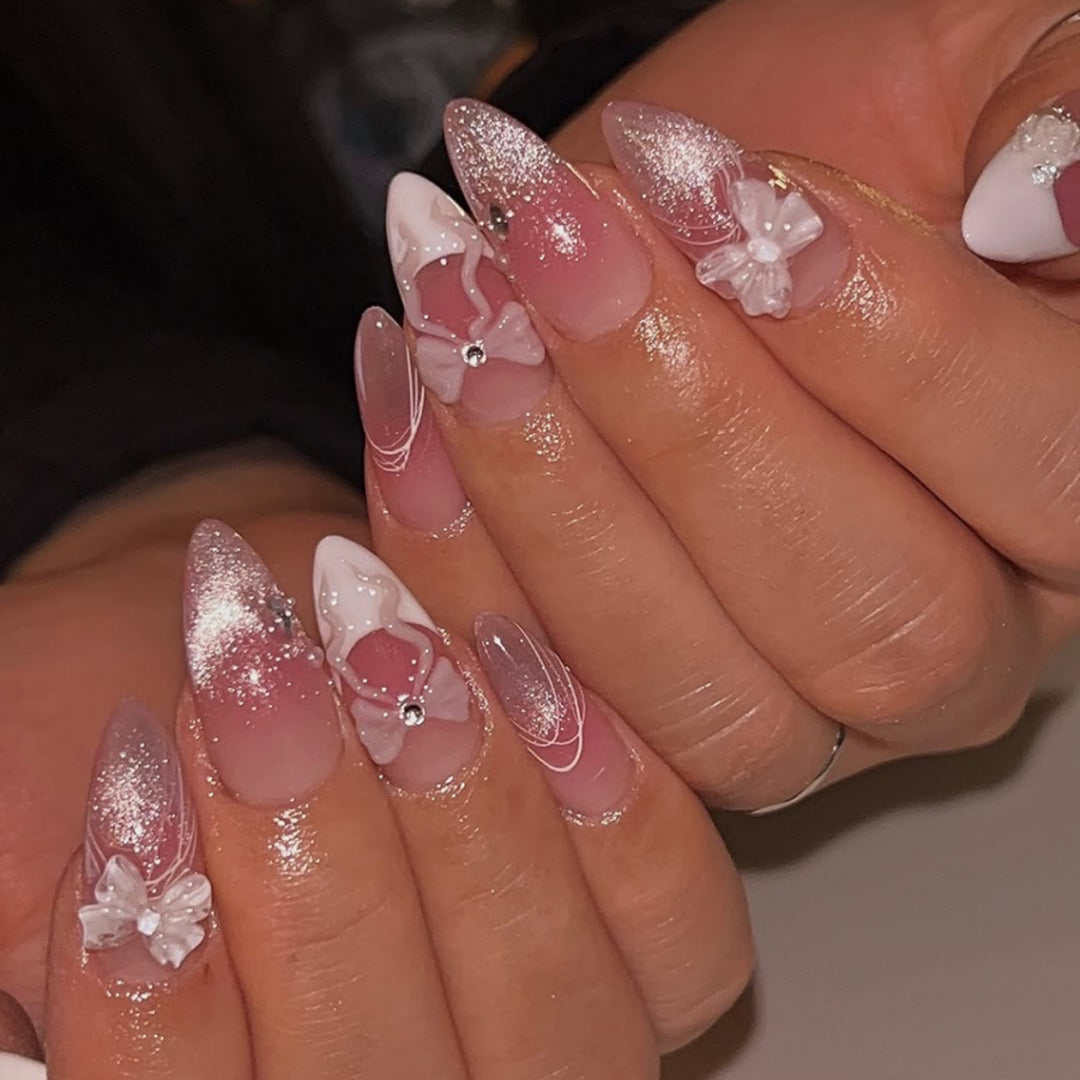 Artful acrylic nails with floral design and glitter embellishment Stornfield
