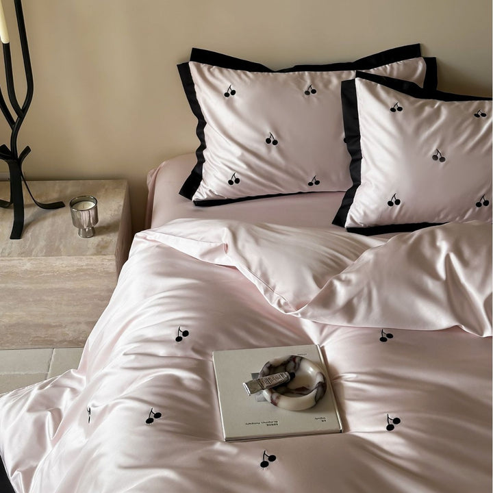 Elegant satin bed set with fine cherry embroidery and contrasting piping
