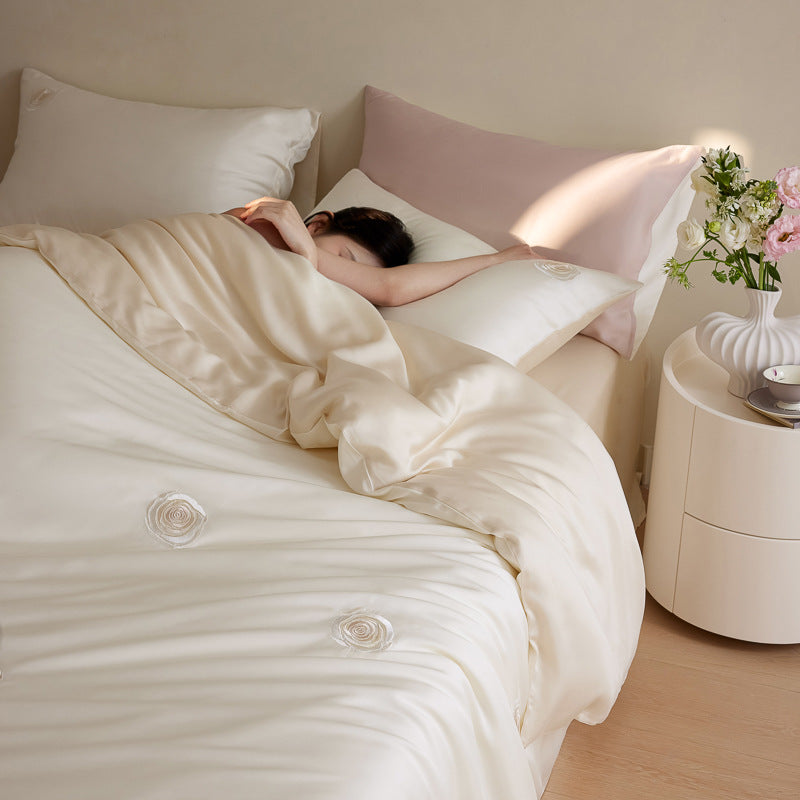 Luxurious satin bedding set with floral embroidered rose details and reversible function