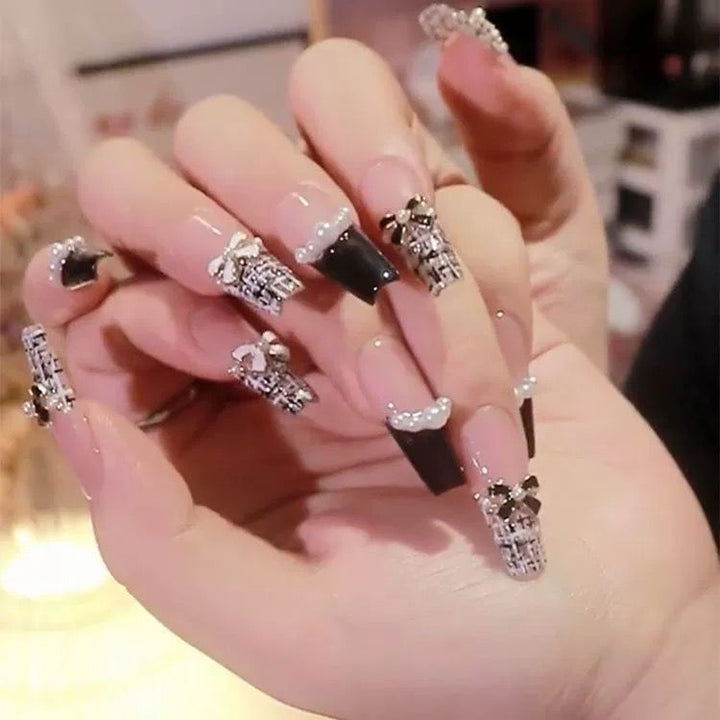Artistic Nail Art with Glitter and Flower Applications Stornfield