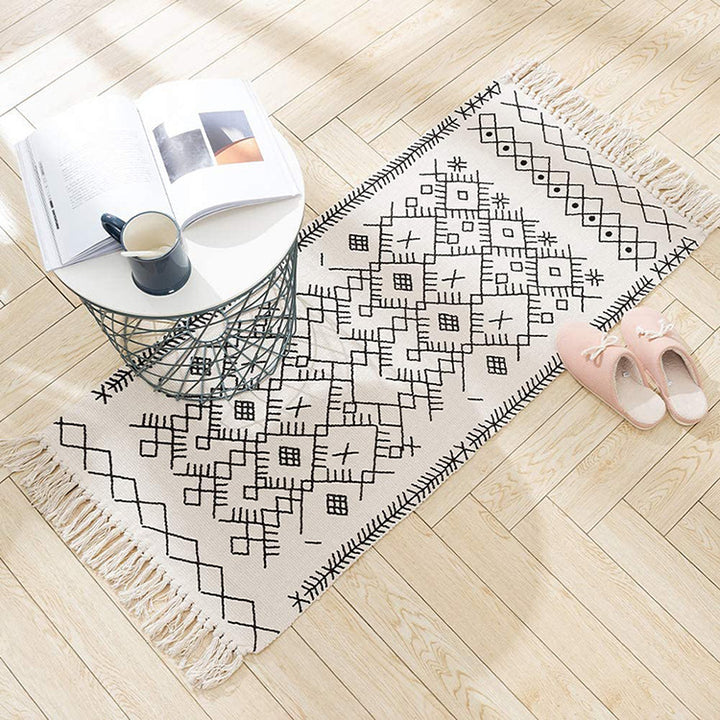 Woven cotton rug runner with flat weave structure, graphic diamond ethnic pattern and fringes