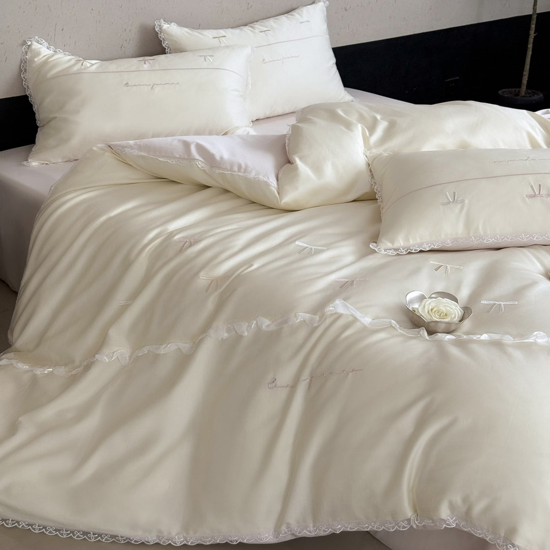 Elegant bedding set made of silky fine satin with embroidered bows and lace trim
