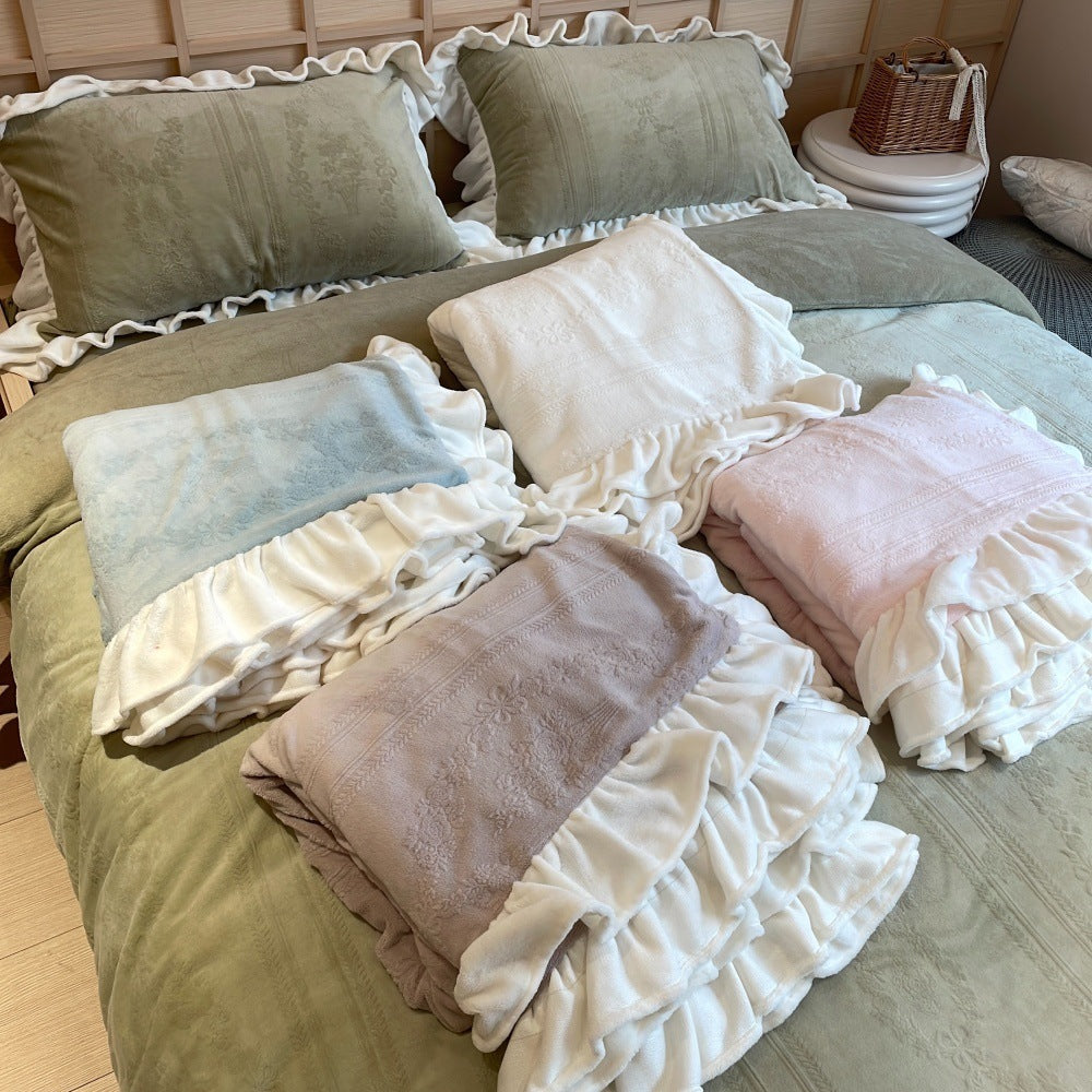Quilted bedding set with ruffle and medallion relief