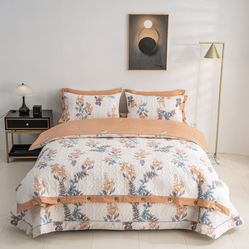 Quilted bedspread and bedding set with floral print, reversible function and decorative button placket