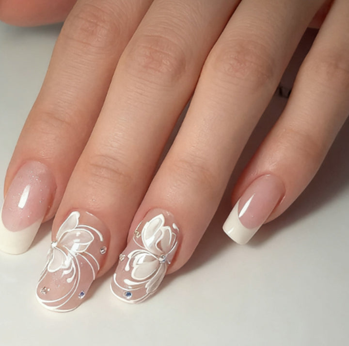Artificial nails with floral embellishments and glitter details Stornfield