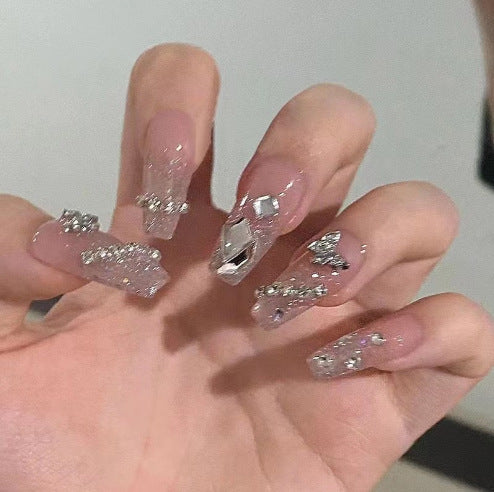 Artistic Nail Art with Glitter and Flower Applications Stornfield