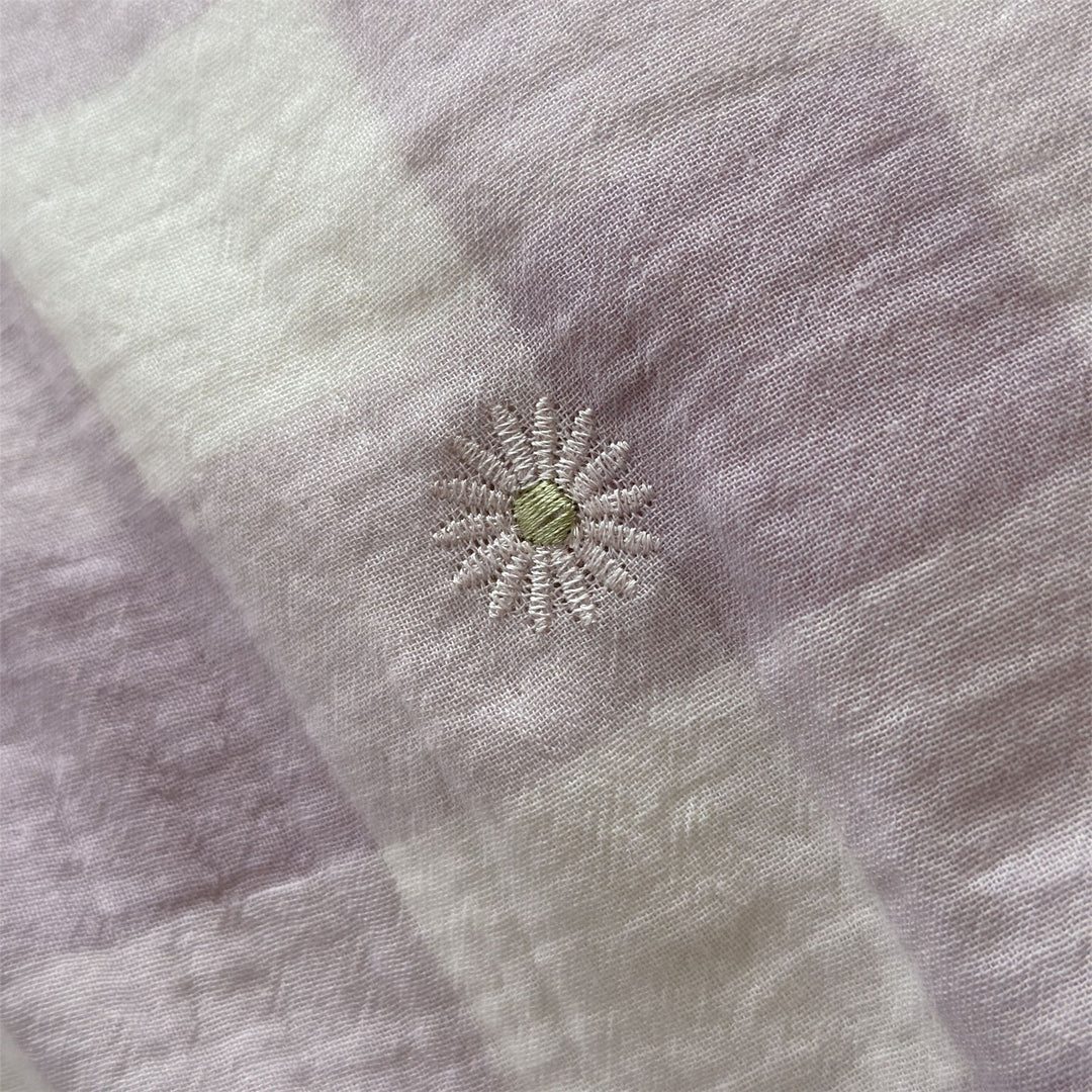 Duvet cover set made of lightweight cotton muslin featuring a checked texture and decorative embroidery design