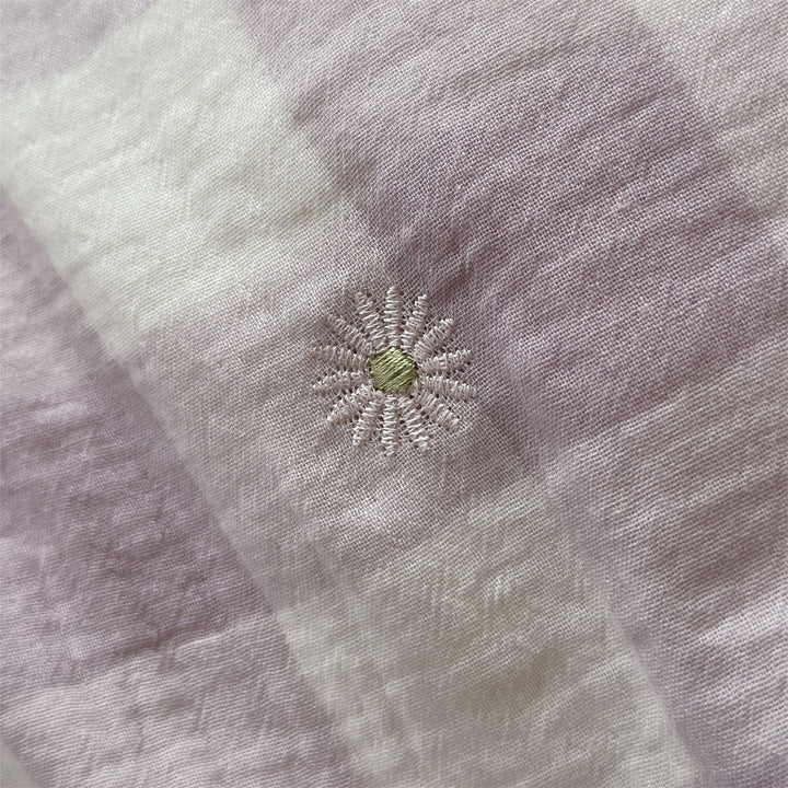Duvet cover set made of lightweight cotton muslin featuring a checked texture and decorative embroidery design