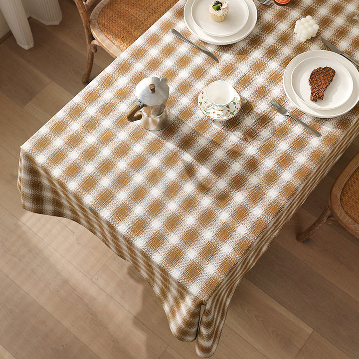 Rectangular checked tablecloth made of cotton blend with pom-pom corners