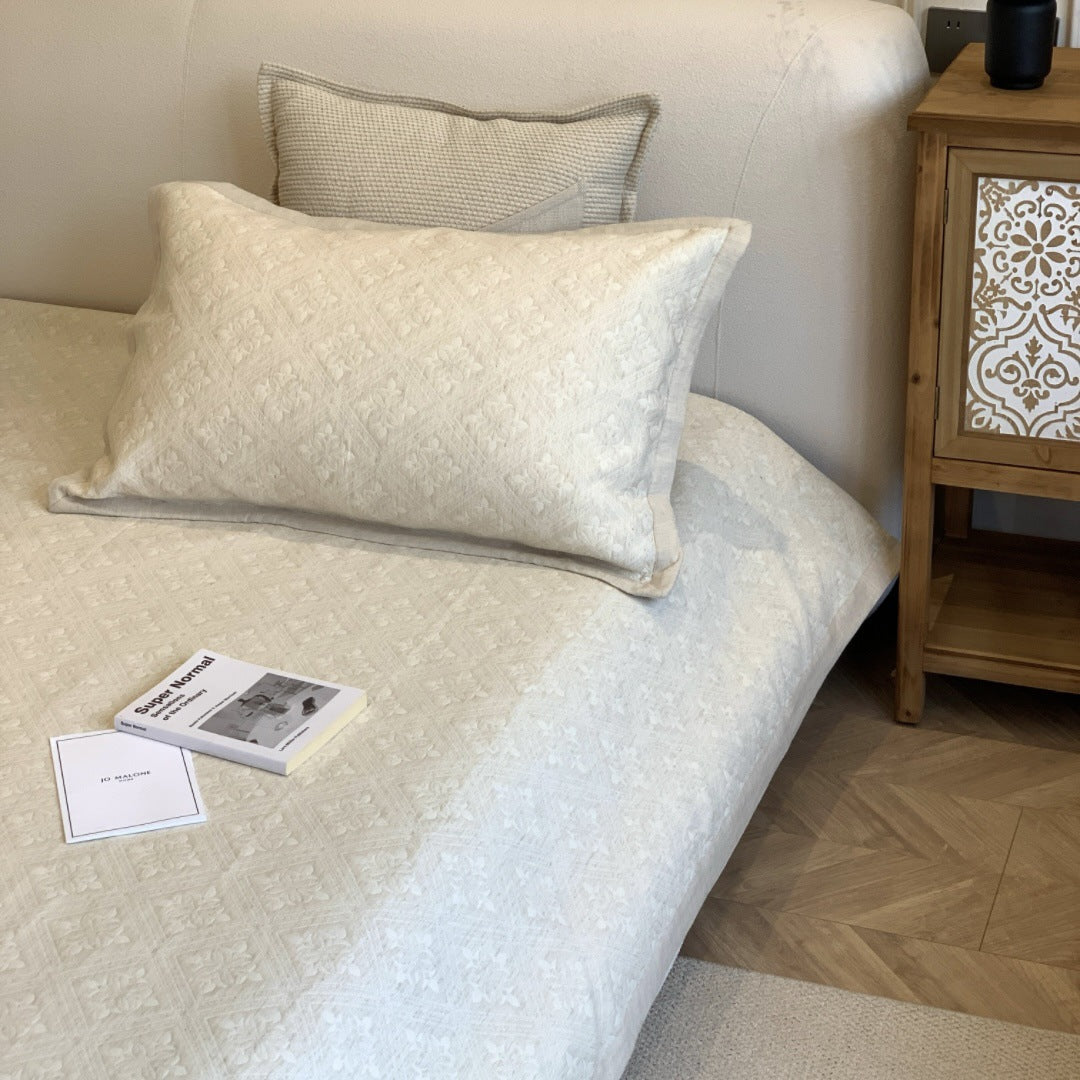 Jacquard cushion cover with quilted diamond pattern and piping