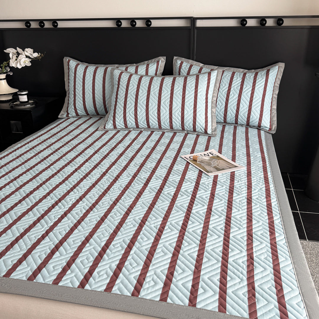 Quilted bedspread and pillow set with geometric striped quilting