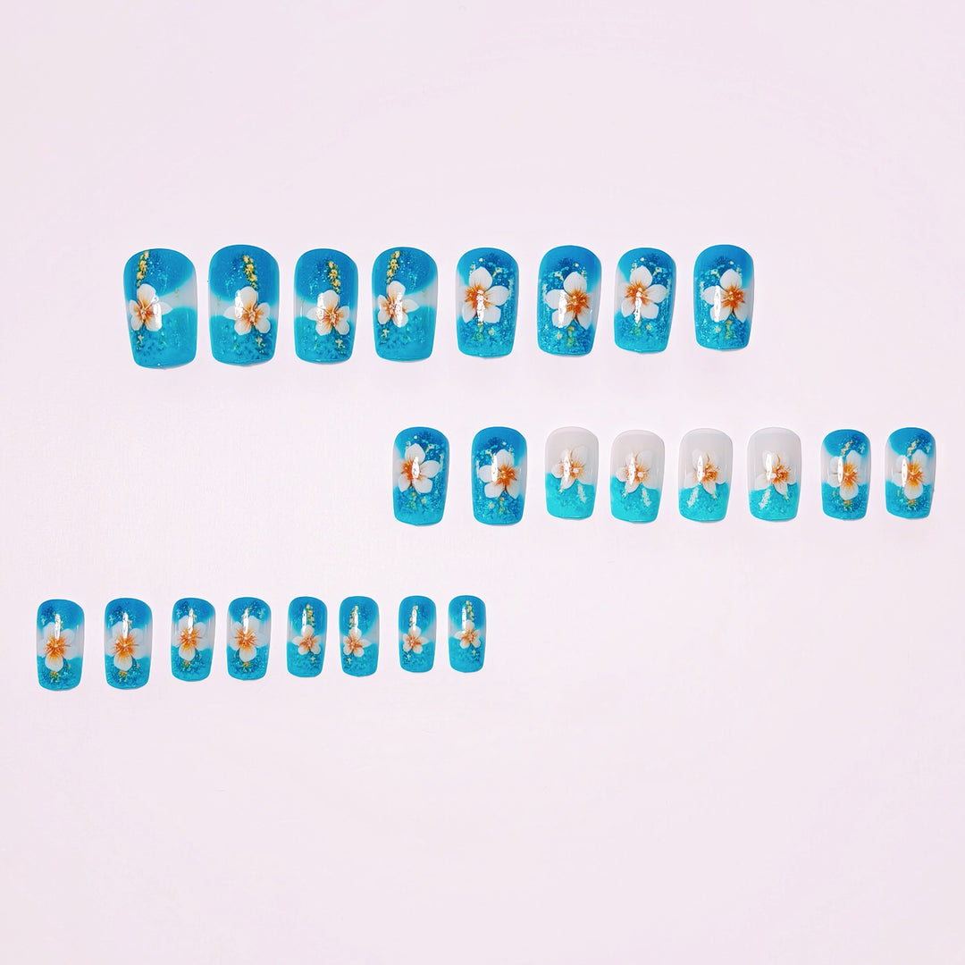 Artificial nails with floral accents and glitter patterns Stornfield