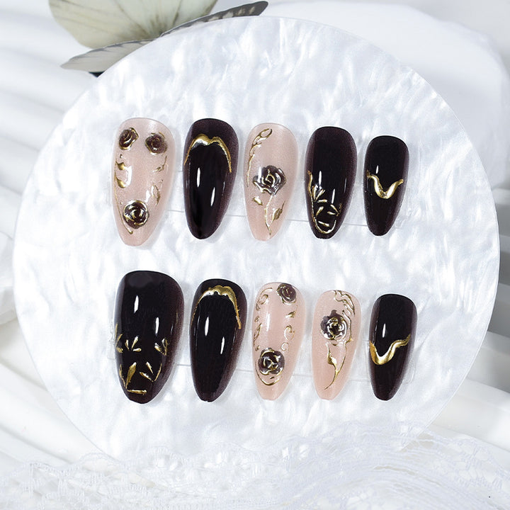 Nail set with elegant gold embellishments and original patterns Stornfield