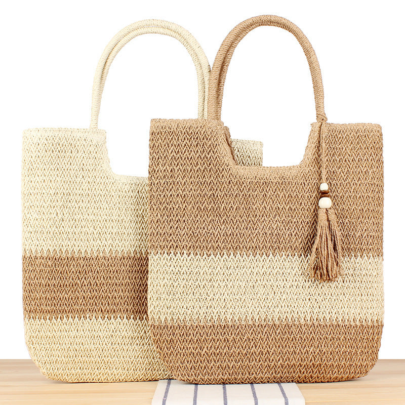 Fashionable beach tote bag made of woven natural material with fringed detail Stornfield