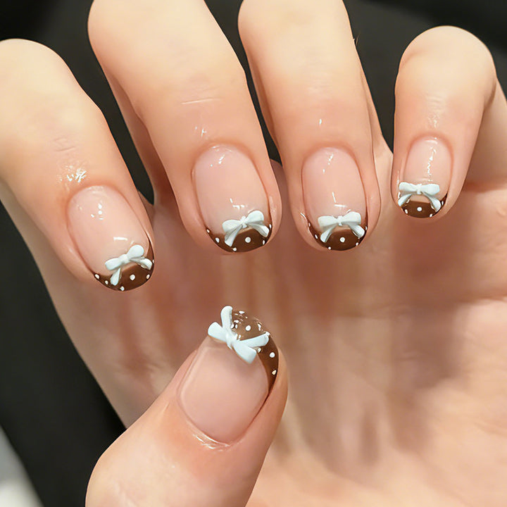 Artificial nail set with playful bows and elegant dots Stornfield