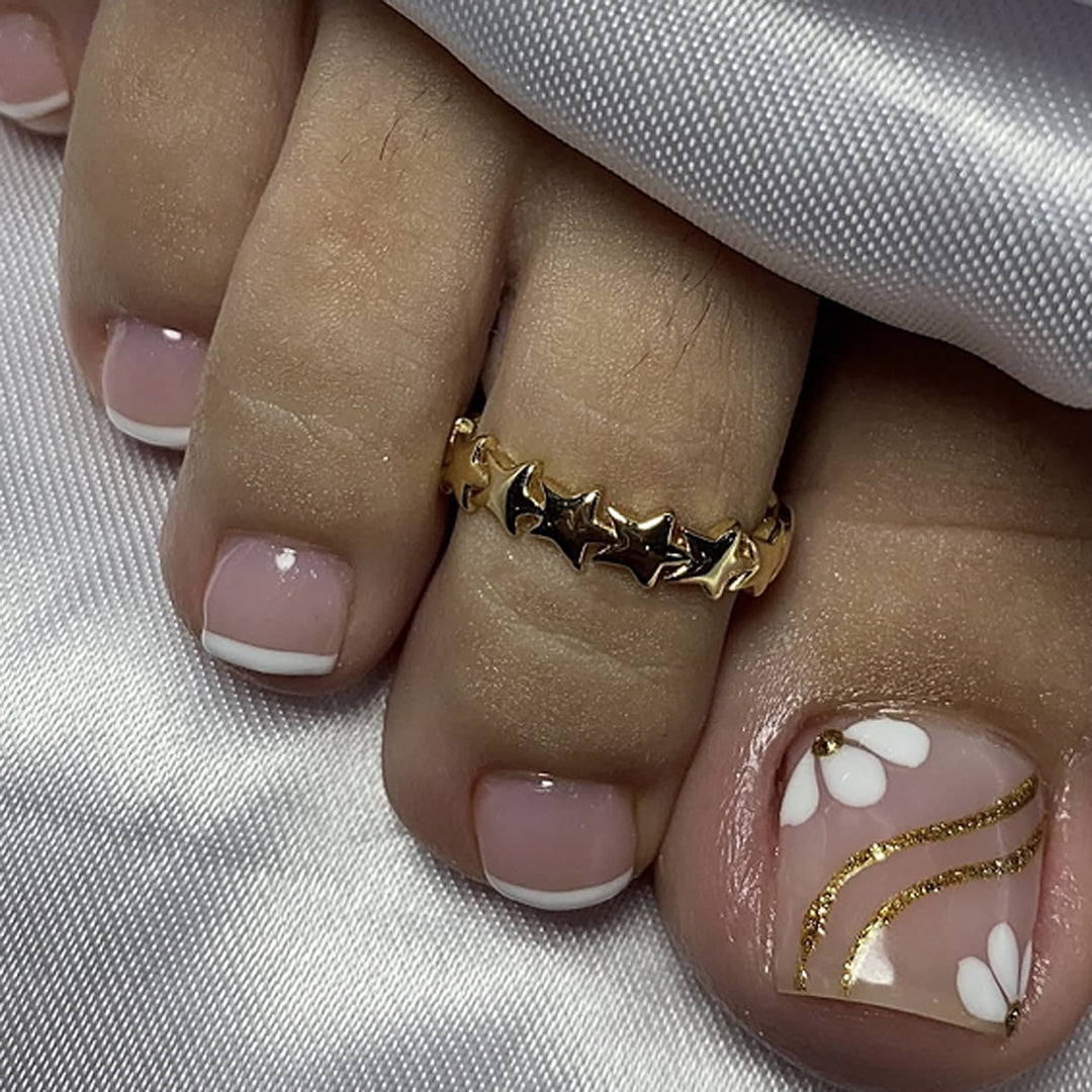 Nail art with elegant blooming designs and glitter accents Stornfield