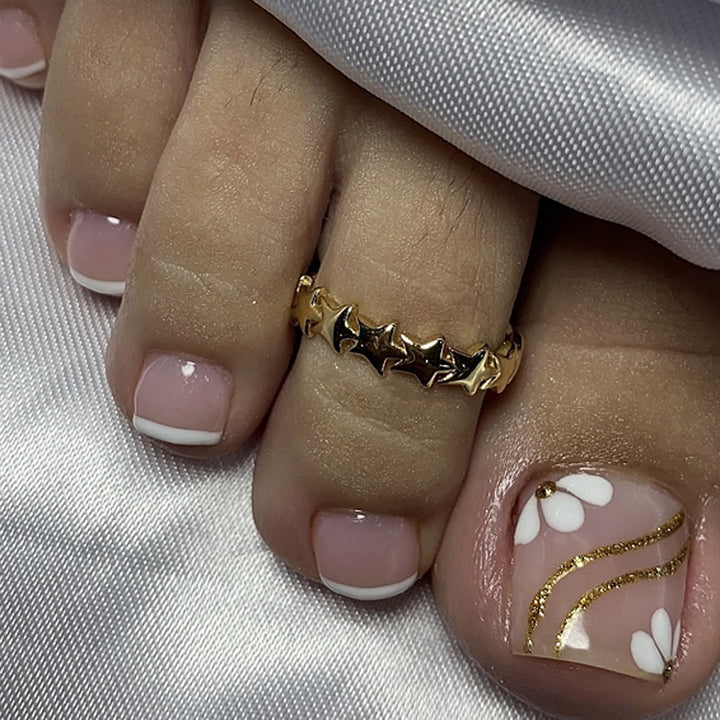 Nail art with elegant blooming designs and glitter accents Stornfield